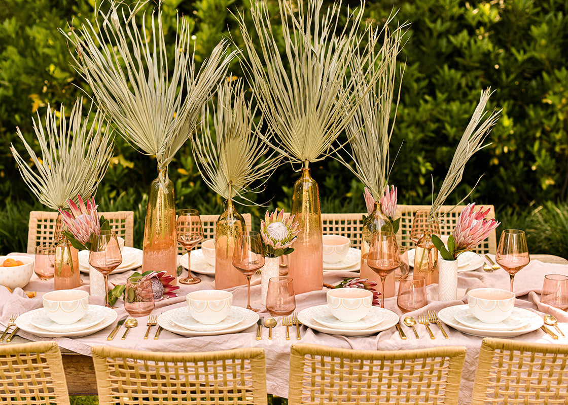 Cropped Close up of a Beautiful Tablescape set with Blush Dinnerware 12 Piece Set and Vases filled with Dried Palms