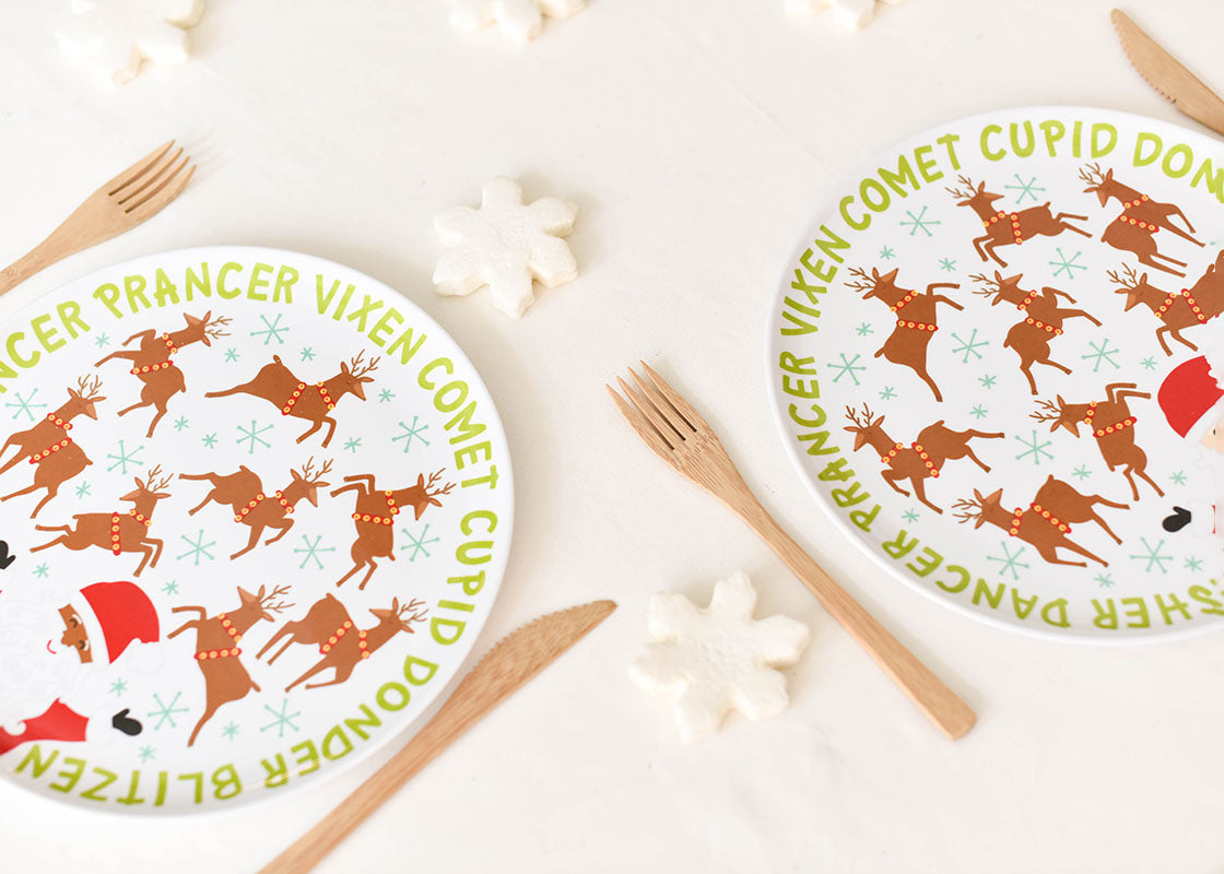 Cropped Close up of Two Place Settings Including Brown Skin Calling All Reindeer Melamine Dinner Plate