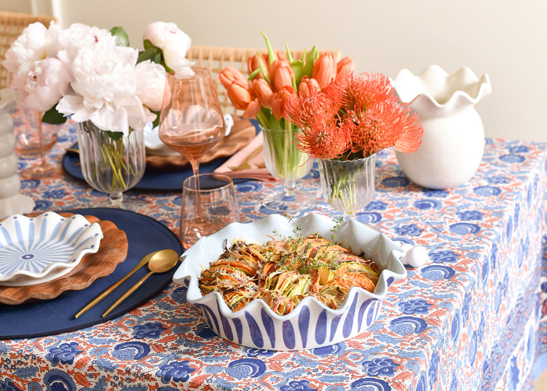 Cropped View of Pretty Blue and Persimmon Tablescape with Ruffled Pie Dish Serving Sweet Potatoes Au Gratin