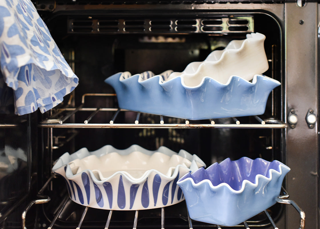 Cropped Close up of Stacked Bakeware on Oven Racks Showing Painted Interiors