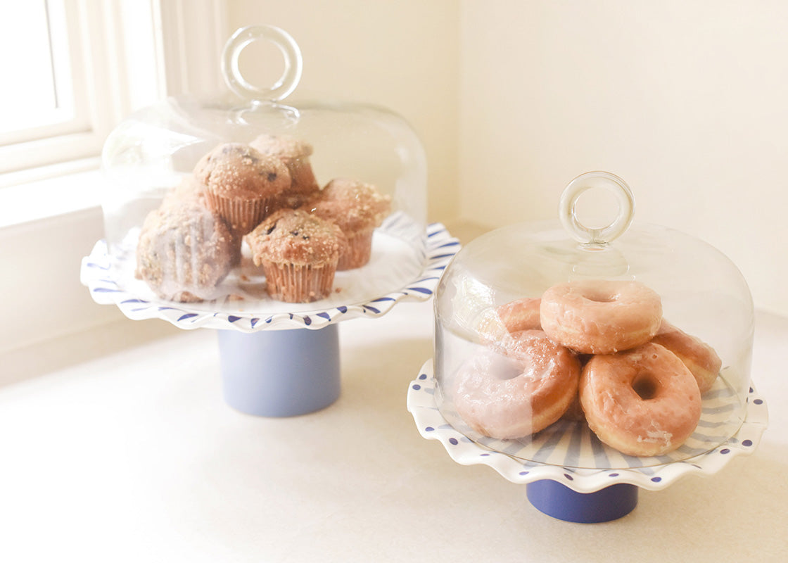 Front View of Two Iris Blue Cake Stands with Glass Domes Covering Stacks of Muffins and Donuts