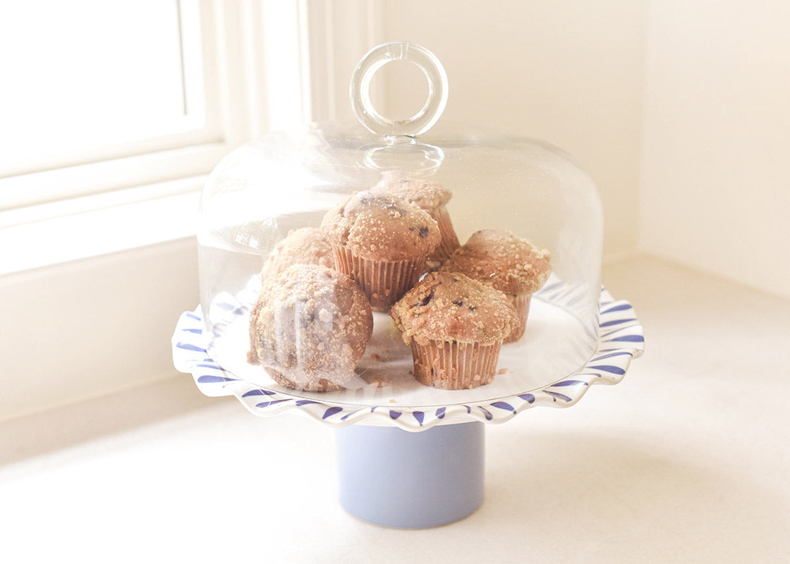 Front View of 14in Iris Blue Ruffle Cake Stand with Ring Dome Placed on Top Covering Stack of Muffins