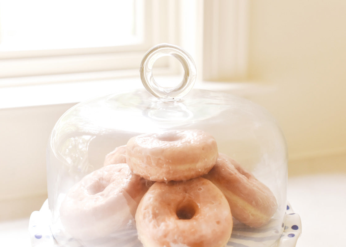 Cropped Close up of Ring Handle on Glass Dome Covering Stacks of Donuts on 11in Iris Blue Ruffle Cake Stand