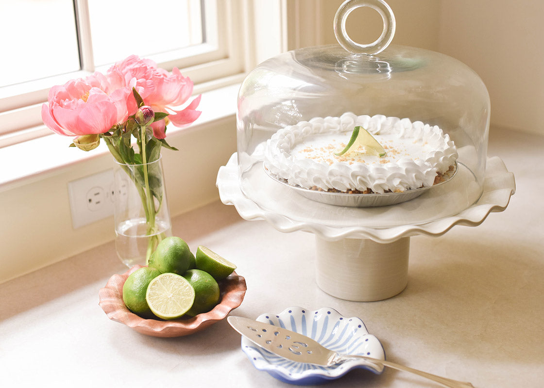 Cropped View of Coordinated Serveware Including 14in Signature White Cake Stand with Large Ring Handle Glass Dome