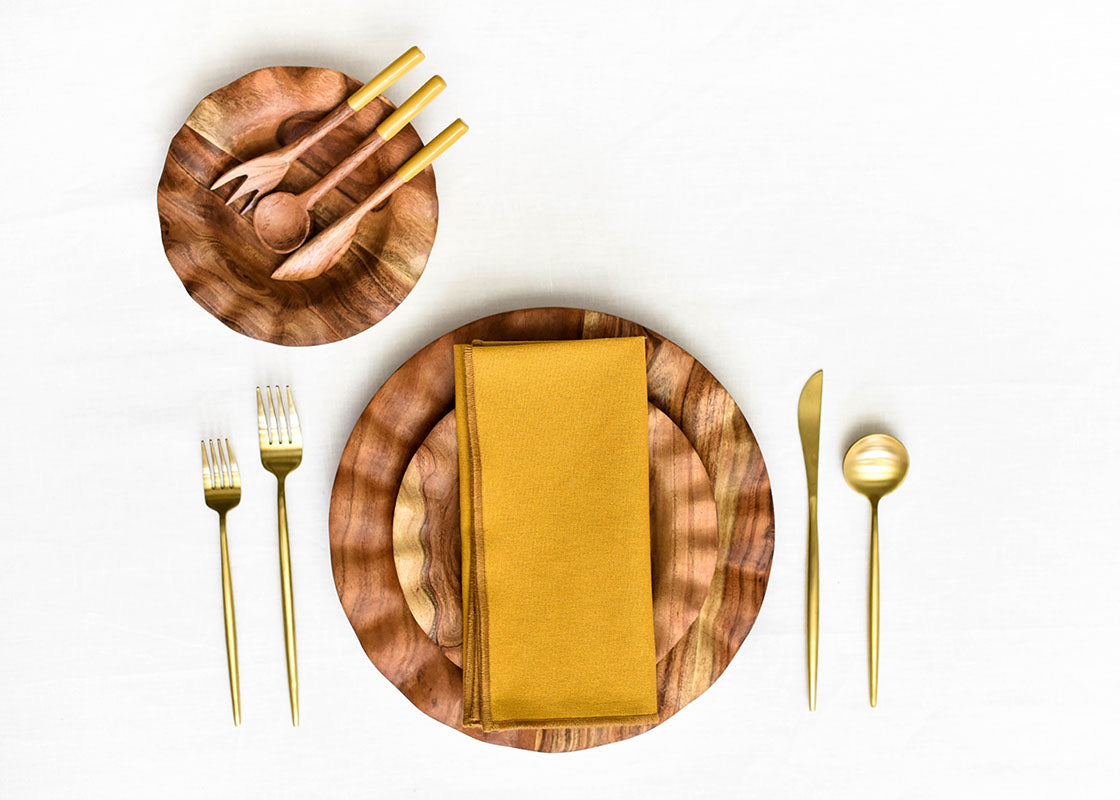 Overhead View of Fundamental Wood Place Setting and Utensils Featuring Brass Appetizer Fork
