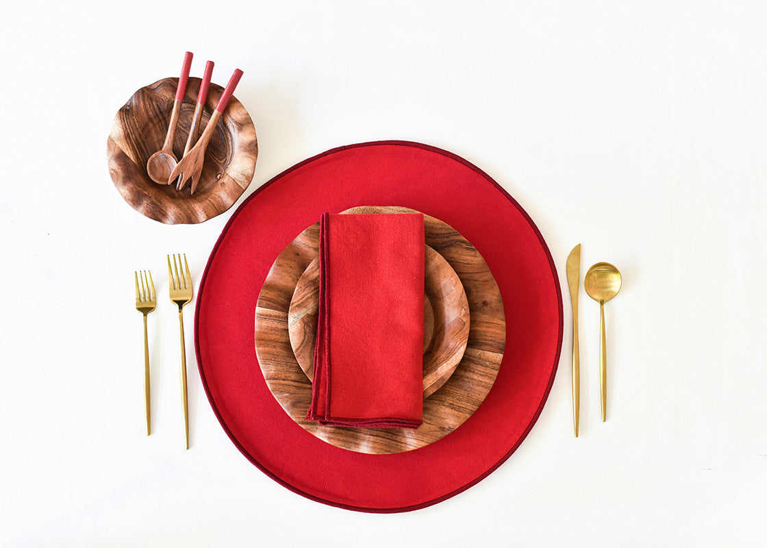 Overhead View of Individual Place Setting Set on Red Color Block Round Placemat