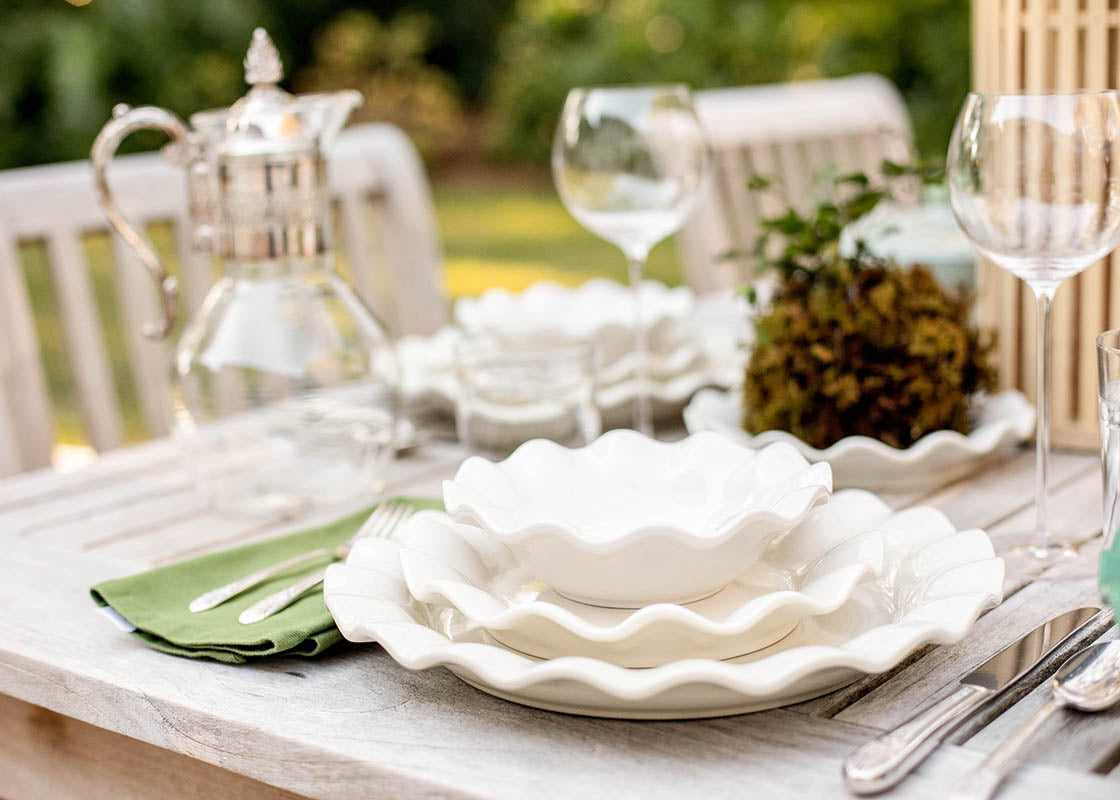 Close up of Individual Place Setting Including Signature White Ruffle Dinner Plate