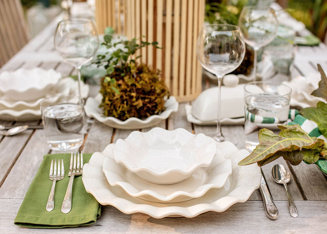 Front View of Palm Themed Tablescape including Signature White Ruffle Salad Plate