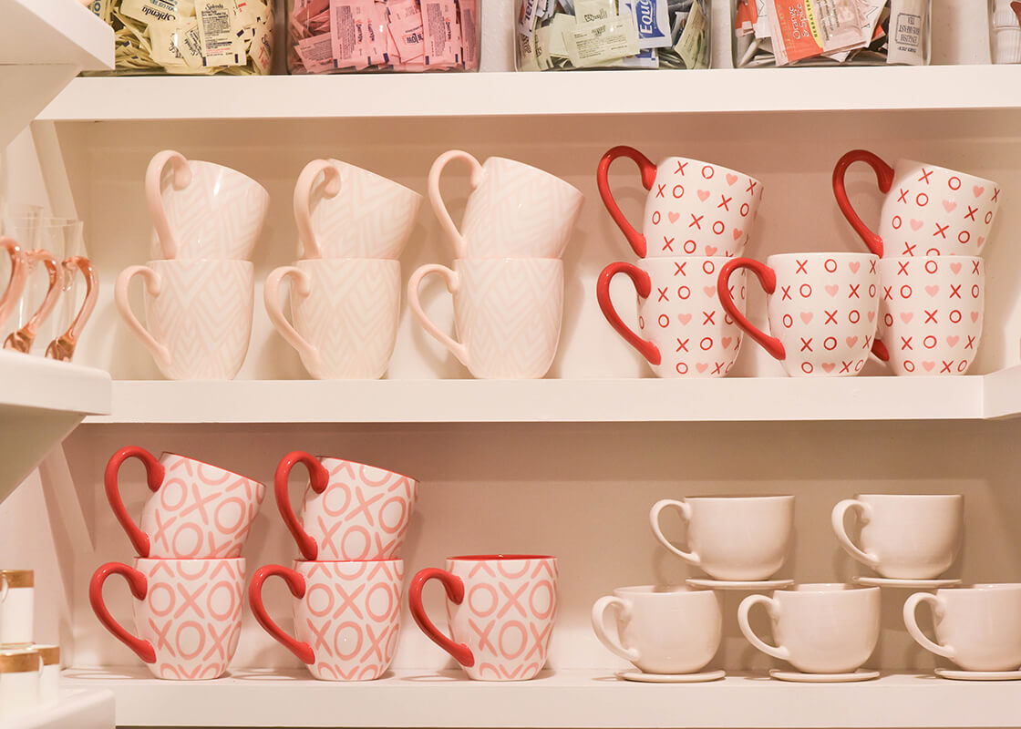 Front View of Coffee Mugs Stacked on Shelving Including XOXO Mug