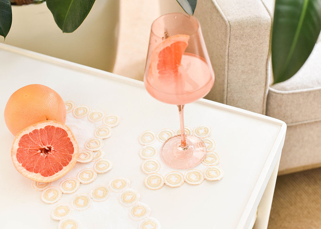 Front View of Blush Wine Glass on Blush Arabesque Cocktail Napkin