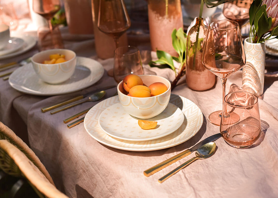 Front View of Blush Accented Tablescape Including Blush Arabesque Trim Small Bowl Filled with Nectarines