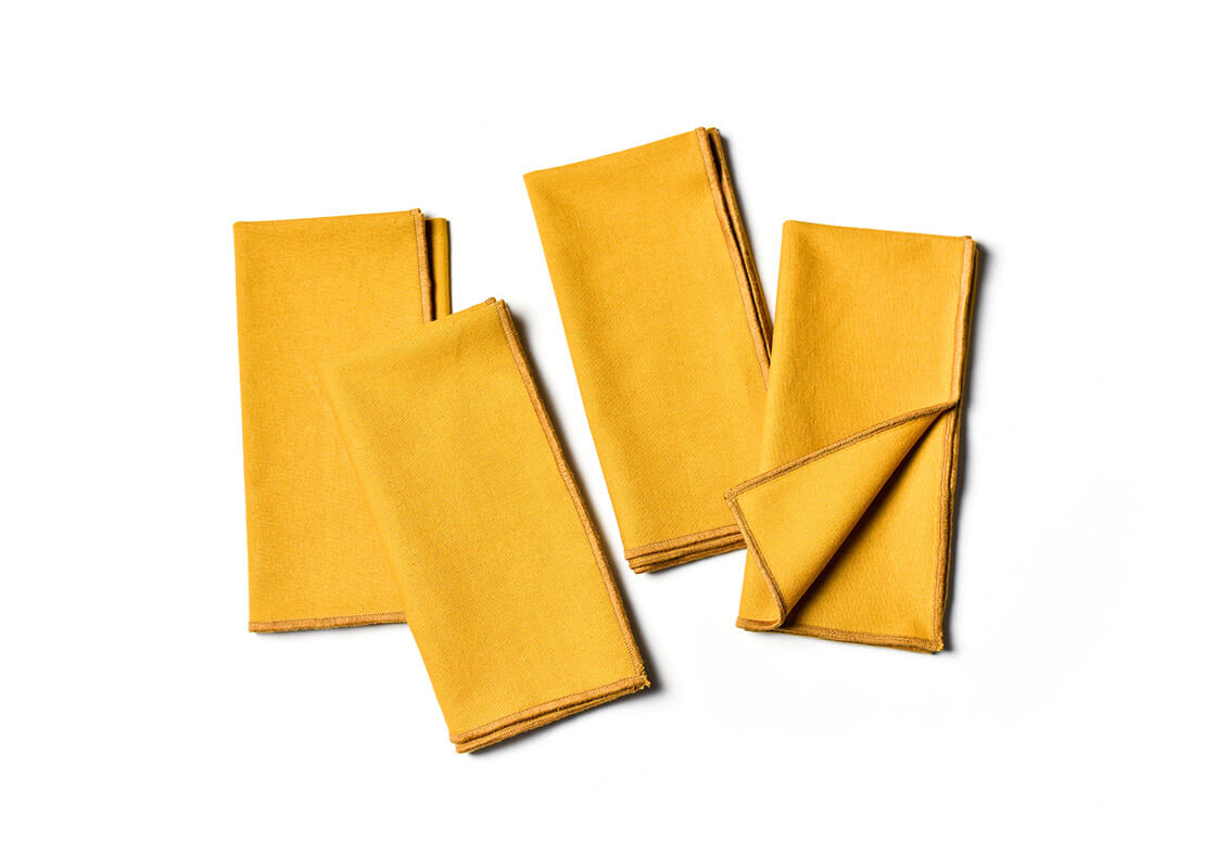 Overhead View of Folded and Creatively Styled Brass Color Block Napkins Set of 4 Showing Personality of Item