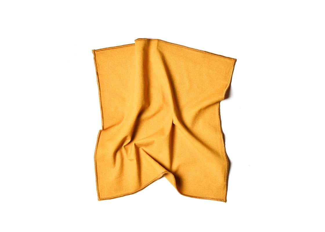 Overhead View of Crumpled Napkin Brass Color Block Napkin Showcasing Texture and Personality