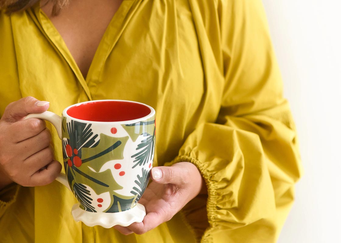 Front View of Woman Holding Holly Ruffle Mug with Both Hands