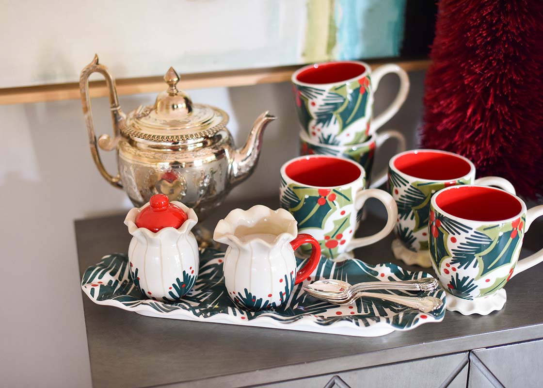 Front View of Side Table Ready for Christmas Morning Coffee Service with Holly Ruffle Mugs Cream and Sugar Set and Silver Coffee Pot