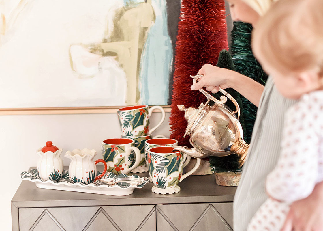 Front View of Woman Holding Child and Pouring into Holly Ruffle Mug