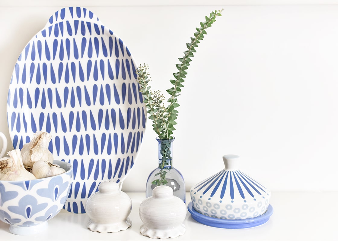 Front View of Coordinating Coton Colors Designs Including Iris Blue Burst Round Butter Dish