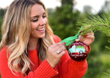 Attaching O Christmas Tree Farm Ornament with Green Bow on Christmas Tree