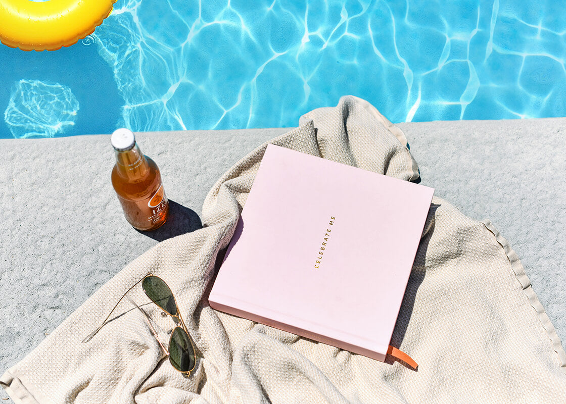 Overhead View of Poolside with Pink Celebrate Me Book Ready to Document All of Baby's Beautiful Days