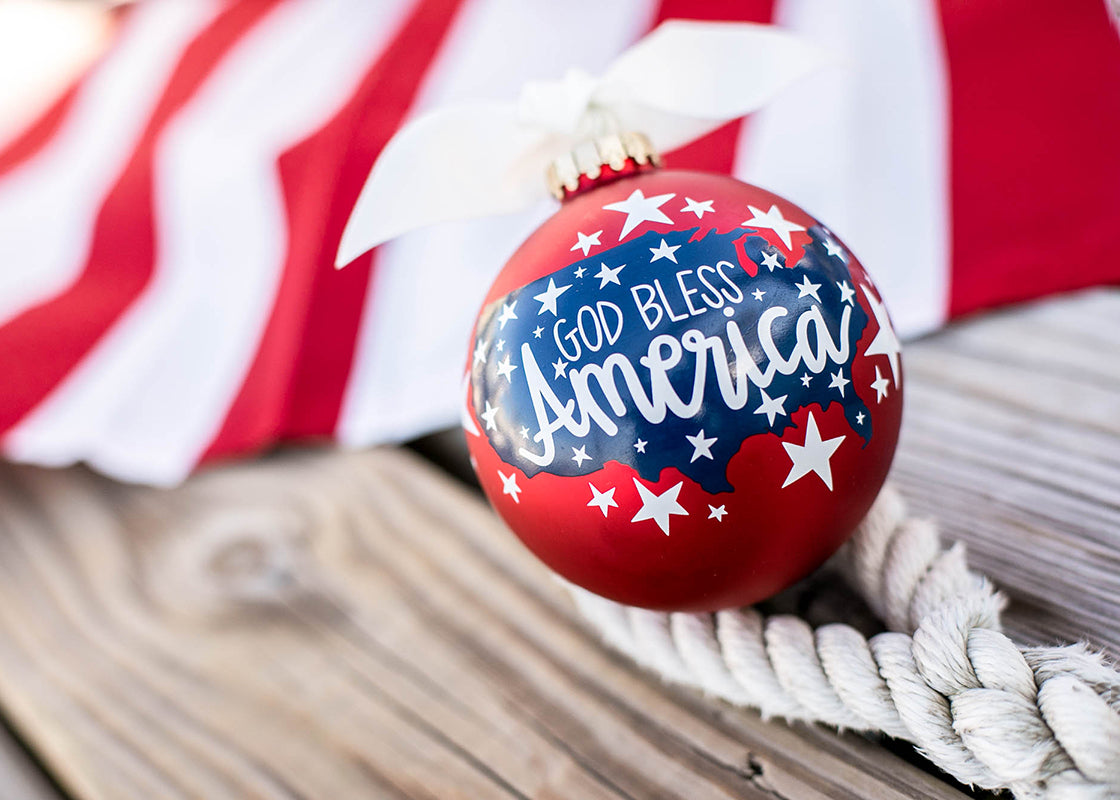 Front View of God Bless America Ornament Set next to American Flag