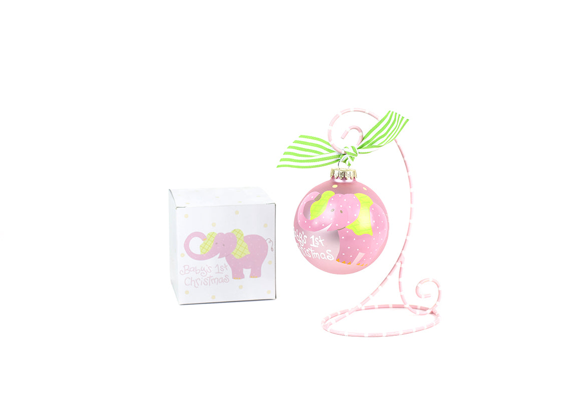 Front View of Pink Baby's First Christmas Elephant Glass Ornament Placed on Pink and White Stripe Display Stand with Matching Box