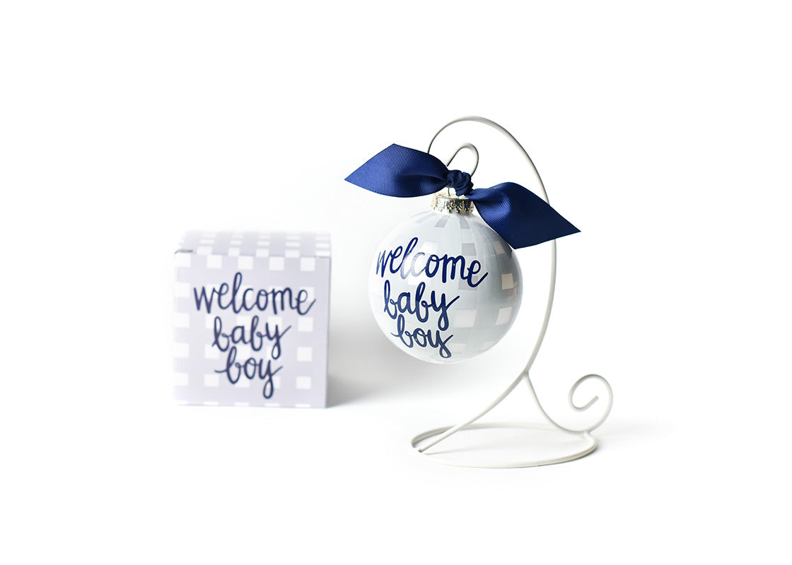 Front View of Welcome Baby Boy Gingham Glass Ornament Placed on White Display Stand with Matching Box