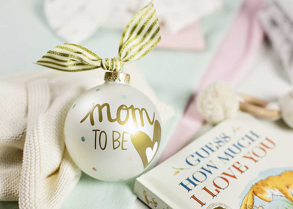 Cropped Close up of Gold Striped Bow on Ornament for Mom to Be with Children's Book