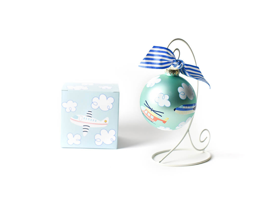 Front View of Around the World Plane Glass Ornament Placed on White Display Stand with Matching Box