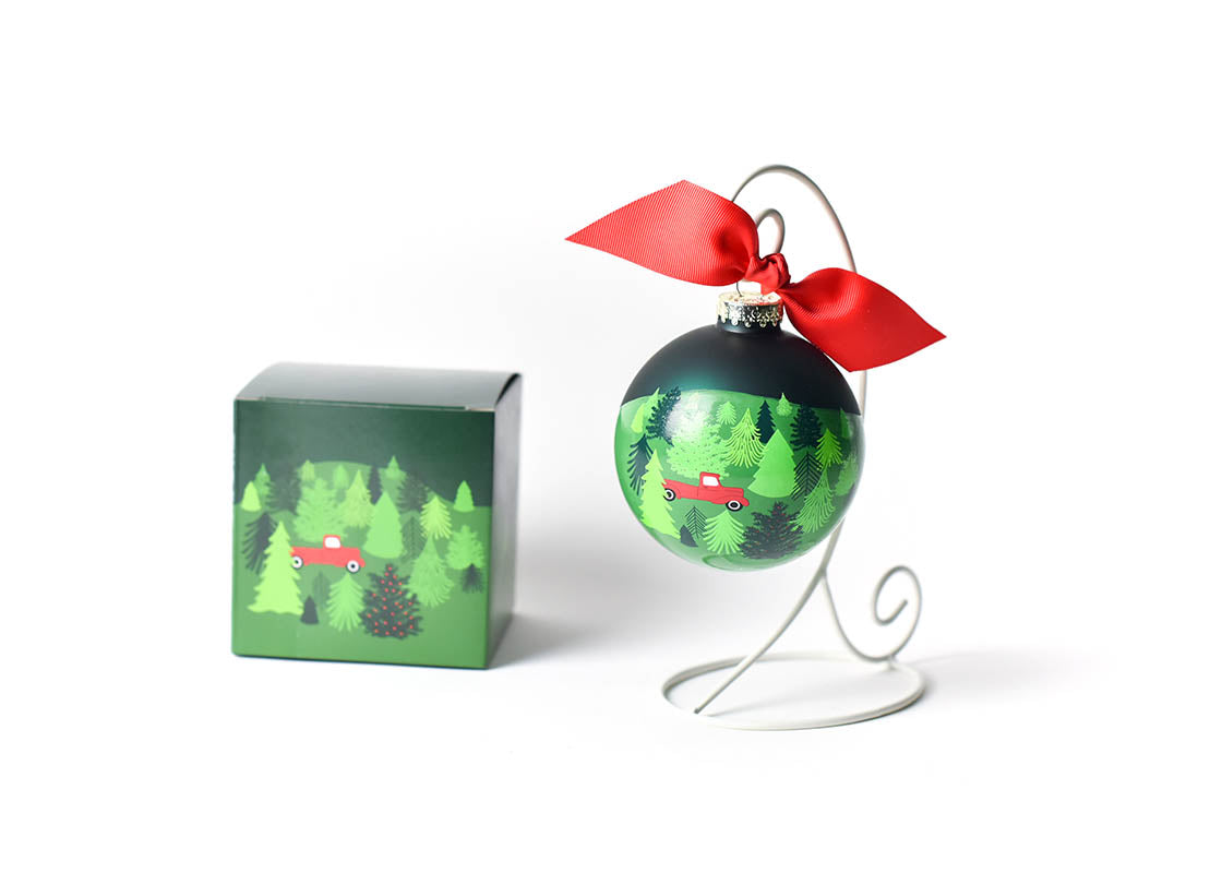 Front View of Truck on a Tree Farm Glass Ornament Placed on White Display Stand with Matching Box