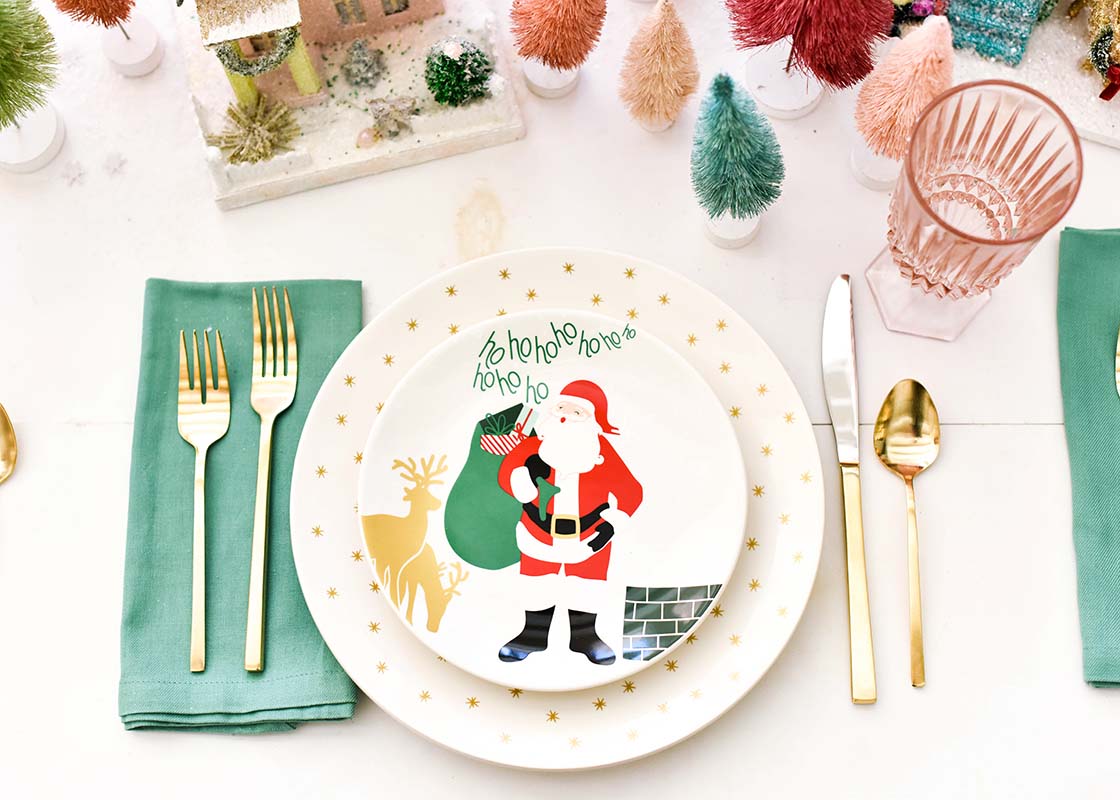 Overhead View of Coordinated Coton Colors Holiday Place Setting Including a Santa on the Rooftop Salad Plate
