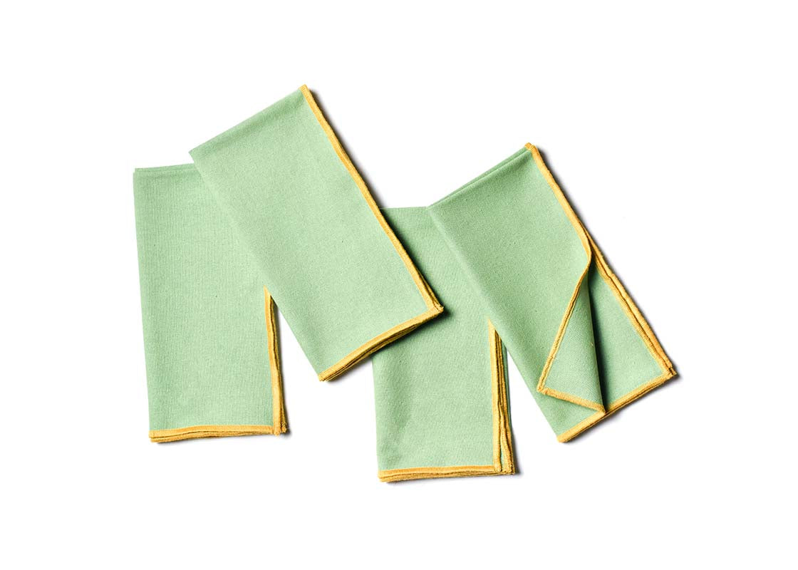 Overhead View of Folded and Creatively Styled Sage and Brass Color Block Napkins Set of 4 Showing Personality of Item