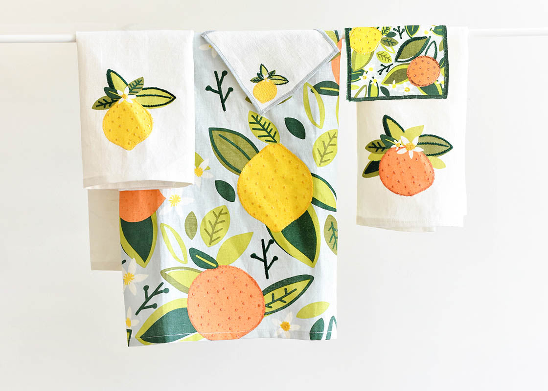 Front View of Citrus Linen Collection Including Lemon Small Hand Towel Folded and Hanging on Rod