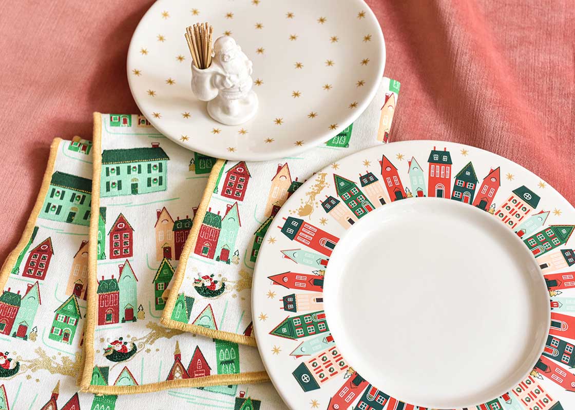 Cropped Close up of Coton Colors Christmas Dinnerware Including Flying Santa Rimmed Dinner Plate