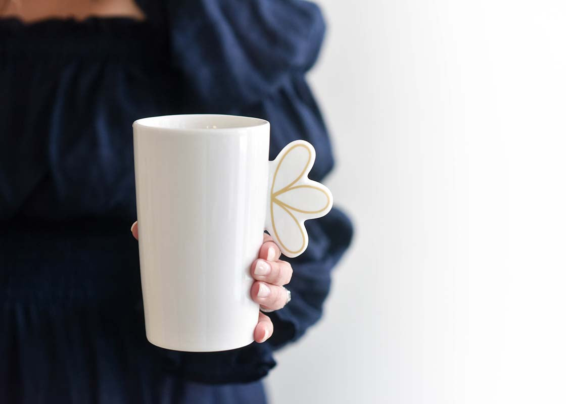 Close up of Woman Grasping Deco Gold Scallop Mug