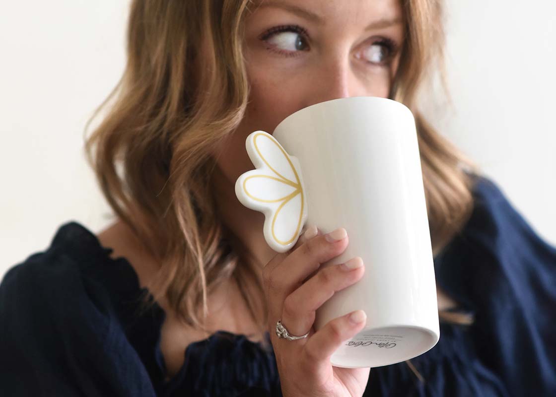 Cropped Close up of Woman Sipping from Deco Gold Scallop Mug While Looking to Side