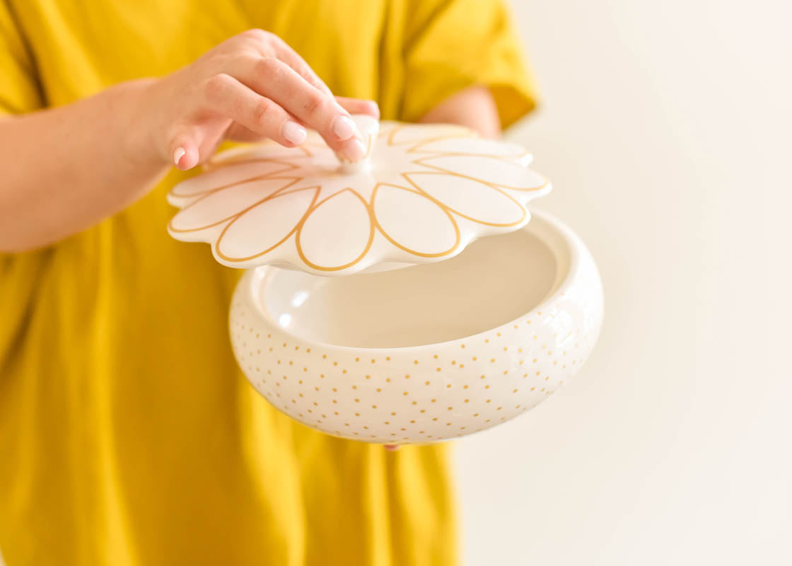 Front View of Woman Holding Deco Gold Scallop Covered Bowl and Lifting Lid by Knob