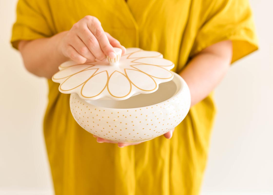 Close up of Woman Holding Deco Gold Scallop Covered Bowl and Lifting Lid