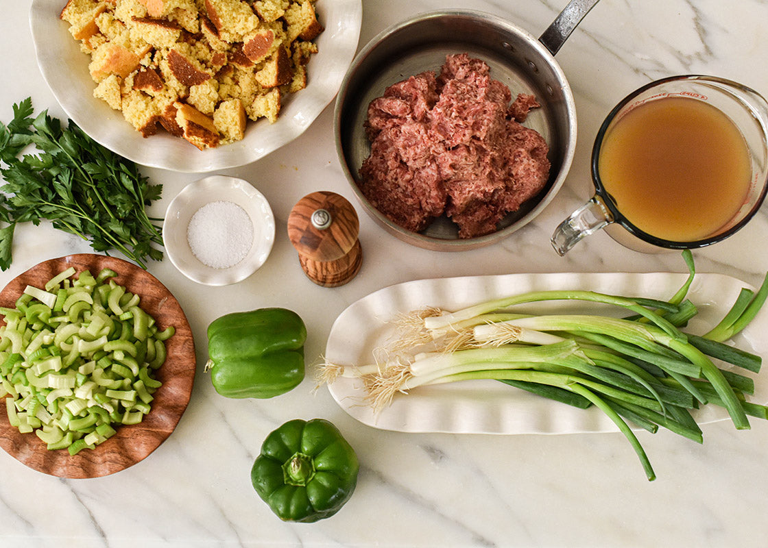 Overhead View of Coordinating Pieces Including Fundamental Wood Ruffle Salad Plate Filled with Cooking Ingredients