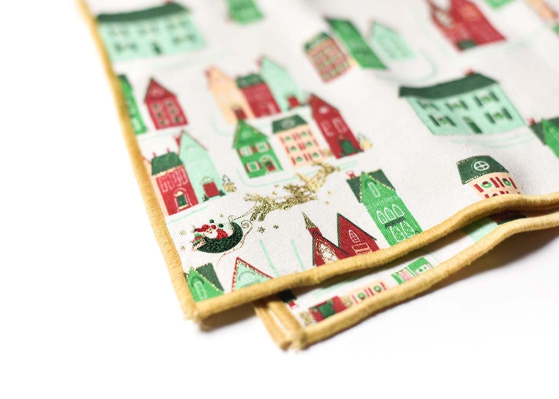 Cropped Close up of Gold Hem Stitched Edge on Folded Flying Santa Napkins Set of 4 Showcasing Beautiful Texture of Fabric