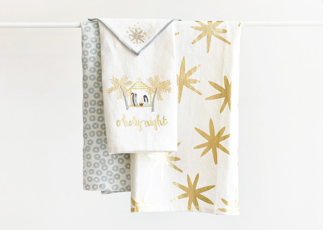 Front View of Coton Colors Linens Including Large Hand Towel Gold Stars Design Folded and Hanging on Rod