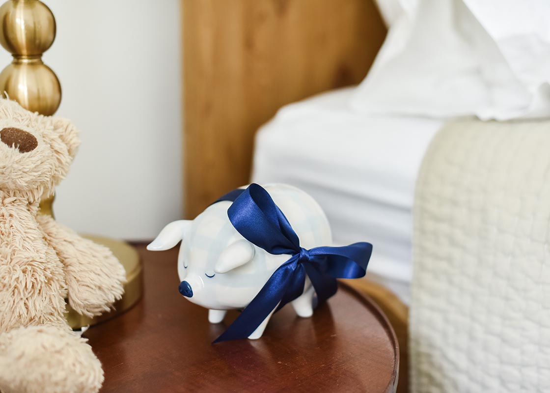 Cropped View of Blue Gingham Piggy Bank Tied with Navy Blue Bow