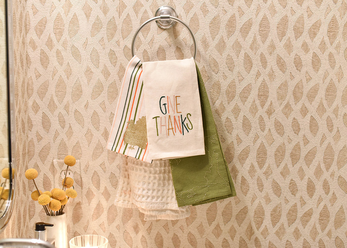 Front View of Layered Towels Including Dusk Give Thanks Medium Hand Towel Hung in Powder Room