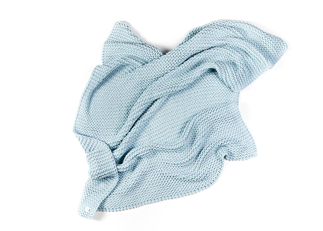Overhead View of Crumpled to Show Texture and Personality of Blue Knitted Blanket