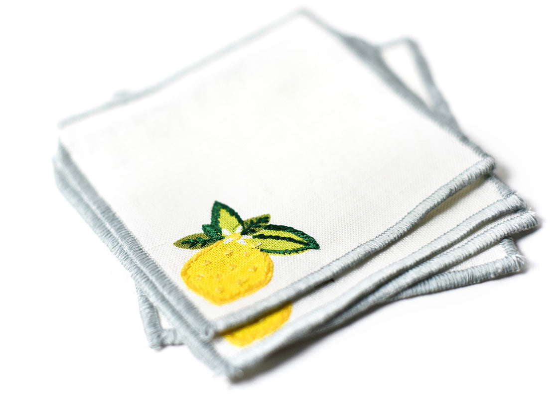 Cropped Close up of Detailed Embroidery on Loosely Stacked Lemon Cocktail Napkins Set of 4 Showcasing Beautiful Texture of Fabric