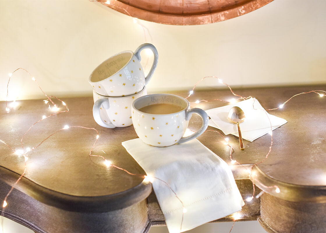 Front View of Nativity-themed Mugs in Twinkle Light Setting