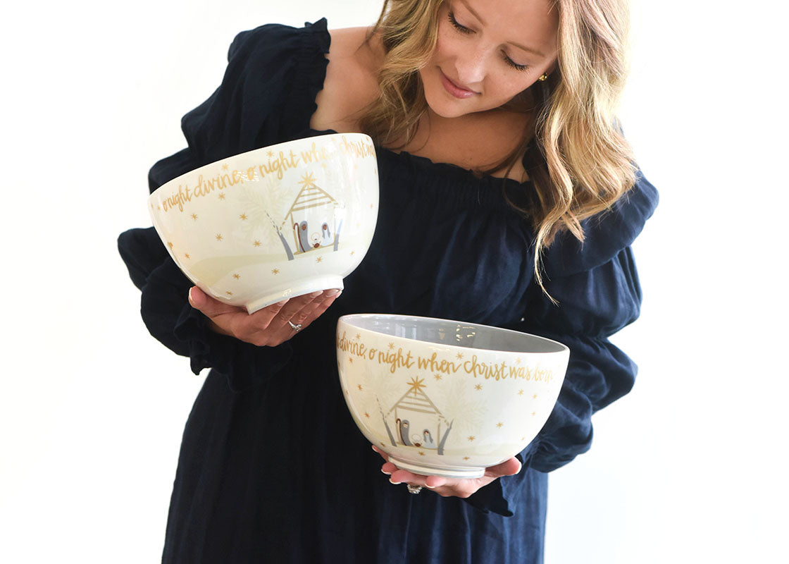 Front View of Woman Holding Two Fair Skin O Holy Night 9in Footed Bowls Admiring their Designs