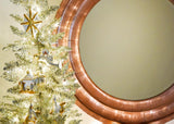 Metallic Gold Star Ornament on Nativity-themed Christmas Tree
