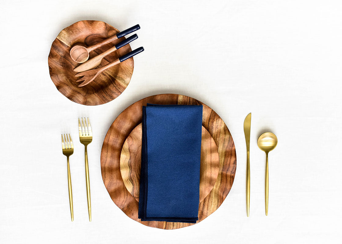 Overhead View of Fundamentals Coordinated Place Setting Including Color Block Navy Napkin Placed on Top