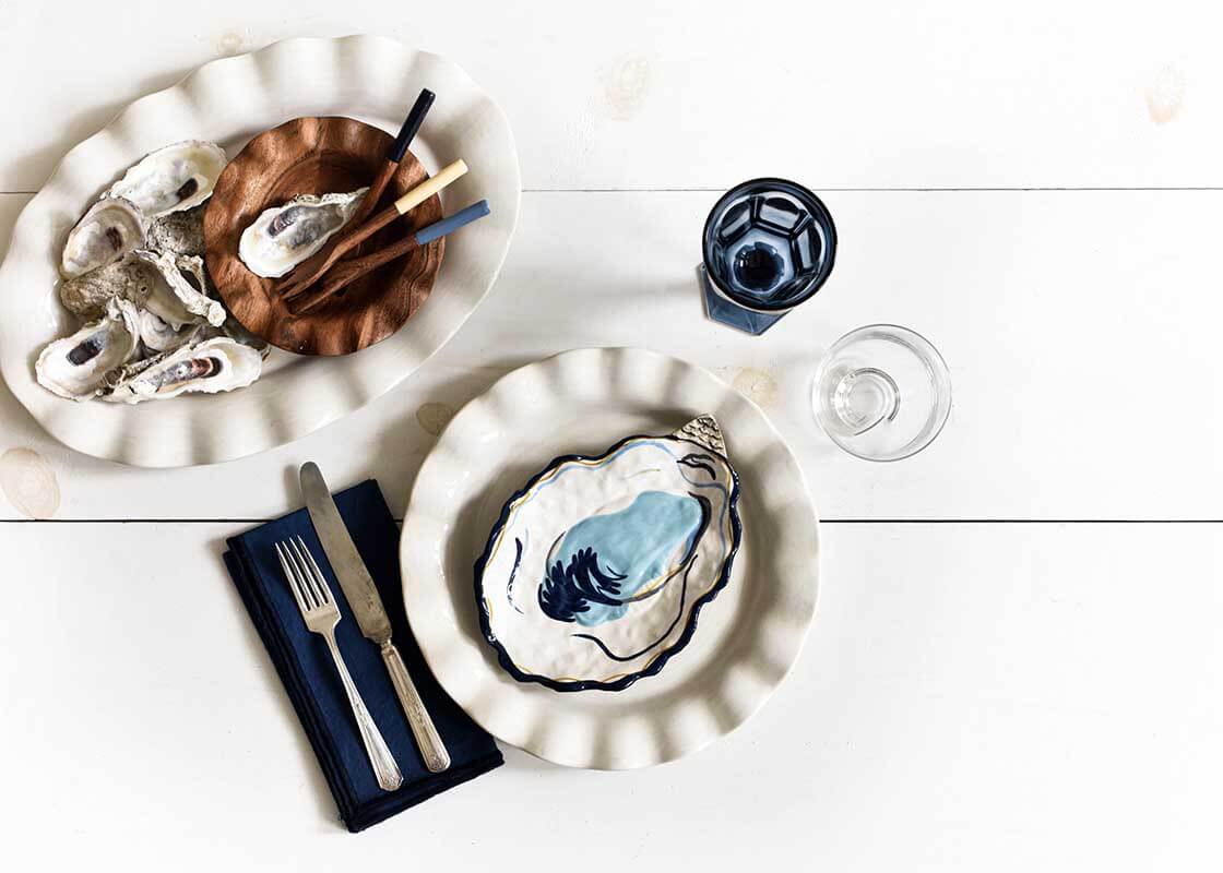 Overhead View of Oysters Being Served on a Mix of Tableware and Navy Color Block Napkin