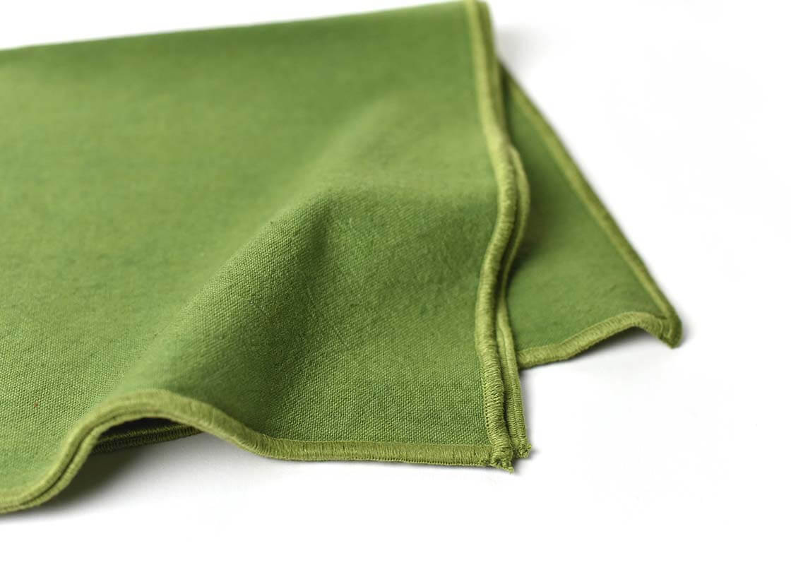 Cropped Close up of Olive Hem Stitched Edging on Folded Olive Color Block Napkins Set of 4 Showcasing Beautiful Texture of Fabric